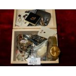 A wooden box of costume jewellery.