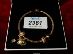 A Pandora yellow metal Charm bracelet with charms.