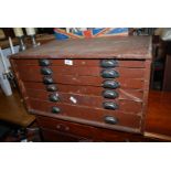 A table top plan chest of six drawers.