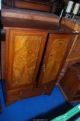 A light and darkwood strung Cupboard with two short over one long drawer to base,
