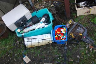 A quantity of miscellanea including a safe, Lego, kitchenware, bottles, and a chainsaw.