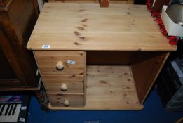 A child's pine desk unit, 29" wide x 19" deep x 28" high.