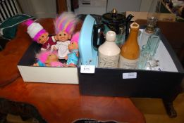 A box of trolls and a box of glass and stoneware bottles, etc.