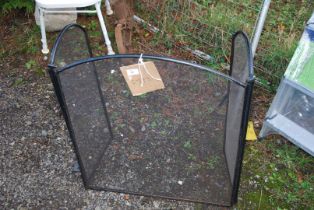 A metal fire guard in fine mesh.