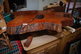 A coffee table made from a tree trunk.