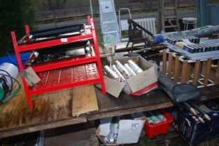 A metal workshop shelves with tray, Soudaflex 36fl floor compound, cased nylon draining rods.