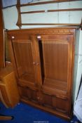 An Ercol "Old Colonial" Oak Display cabinet with glazed doors,
