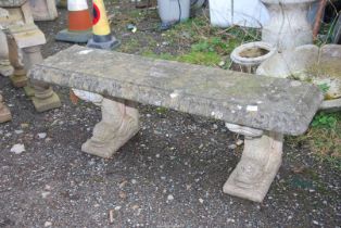 A concrete Bench having dolphin feet, 53'' wide x 15'' deep x 17 1/2'' high.