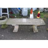 A concrete bench with supports in the form of dolphins, 53'' wide x 15'' deep x 17 1/2'' high.