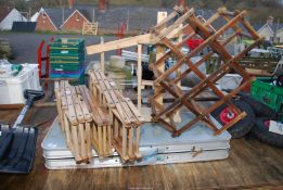 A fold up picnic table and wooden wine racks , etc.