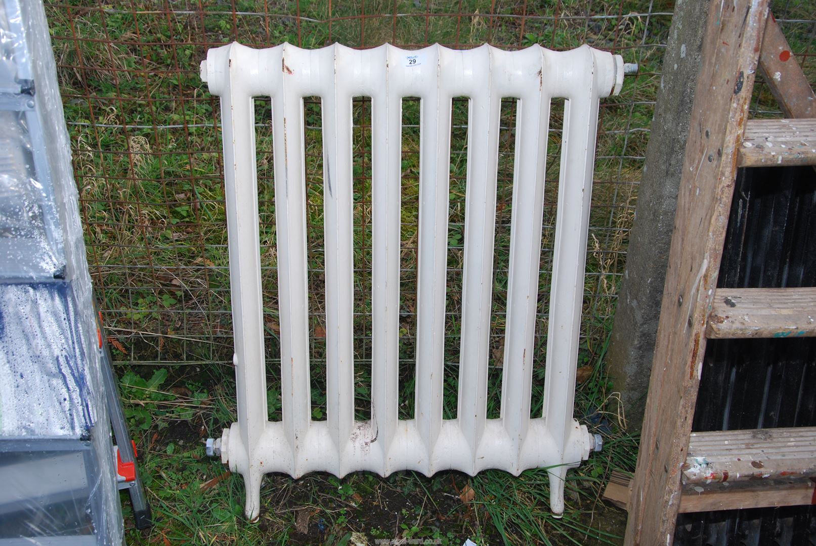 A cast iron radiator, 24'' wide x 32'' high.