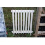 A cast iron radiator, 24'' wide x 32'' high.