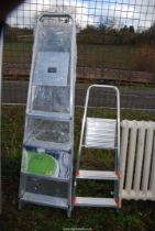 A three rung step ladder and a new five rung step ladder.