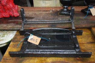 A cast iron bread oven door and a cast iron stand.