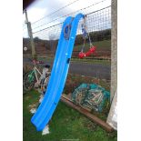 A blue slide and a swing seat with rope.