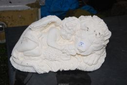 A concrete cherub/lion figure.