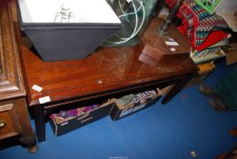 A Mahogany cross banded coffee table with glass protective top,