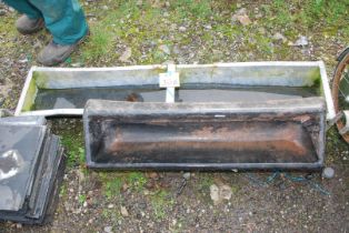 A small galvanised 53½" x 10" feed trough and a plastic feeder trough 34".