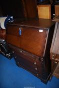 An Oak bureau with four drawers and key, 30'' x 40'' high.