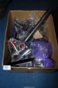 A box of Dyson vacuum attachments.