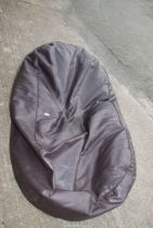 A large faux leather bean bag, 75" long x 46" wide.