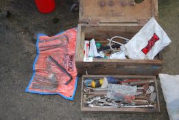 A wooden tool box, ring spanners, open-ended spanners, Kerosin nozzles, etc.