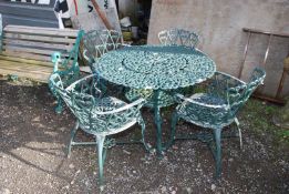 An aluminium green painted 'Jardine Leisure' patio table, 39'' diameter x 26'' high and four chairs.