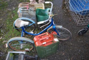 A tricycle and a Jerry can.