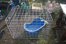 A large dog cage and a dog basket.
