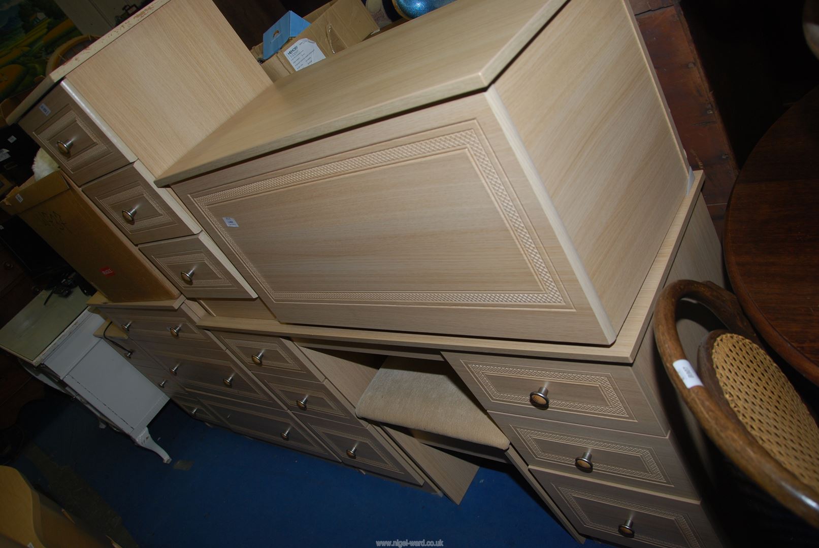 A modern lightwood effect dressing table and stool, chest of drawers and bedside cabinets.