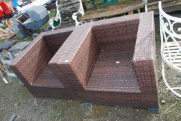 Two large rattan patio chairs.