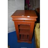 A Satinwood record cabinet with glazed front cassette drawer, 21 1/2'' wide x 19'' deep x 41'' high.