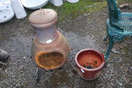 A Chiminea and a plant pot.