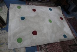 A spotty wool rug, approx. 4' x 6'.