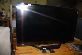 A LG TV with remote, 42" screen.