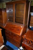 A Mahogany bureau/bookcase, with two short over two long drawers, 33" wide x 16" deep x 69" high.