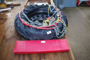 A pair of snow chains, A 5 stud wheel 115/90 R16, a safety triangle.