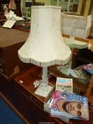 A table lamp and shade in cream and a quantity of Aston Villa programmes.
