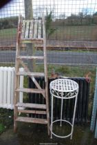 A six rung wooden step ladder and an aluminium plant stand.