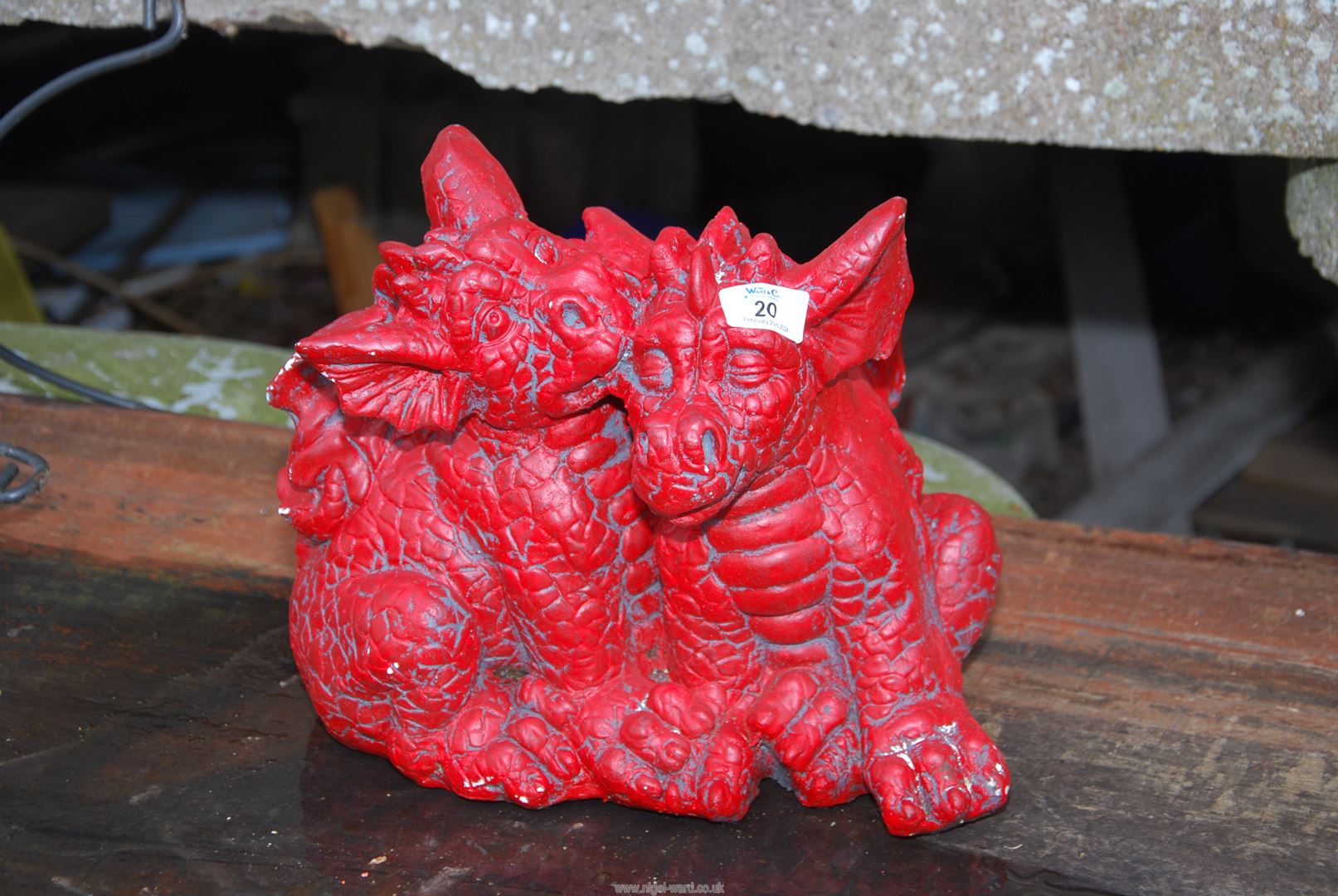 A pair of red painted concrete dragons.