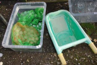 A box of golf balls, plus a Child's wheelbarrow.