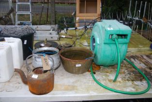A copper jam pan, cast iron kettle, cauldron, hose reel, etc.