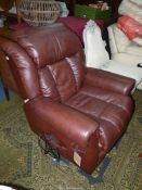 A dark brown upholstered electrically rising and falling Armchair.