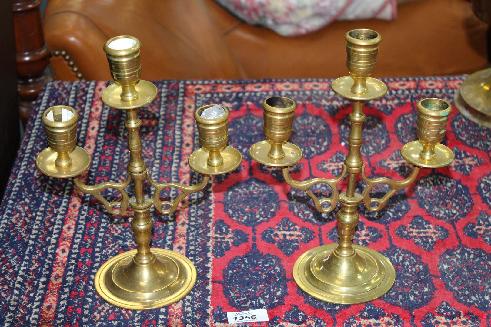 A pair of brass three branch candelabra.