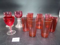 Ten Cranberry glass tumblers and three wine glasses including spiral stemmed,