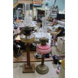 Two oil lamps, one with Corinthian column and cut glass reservoir,