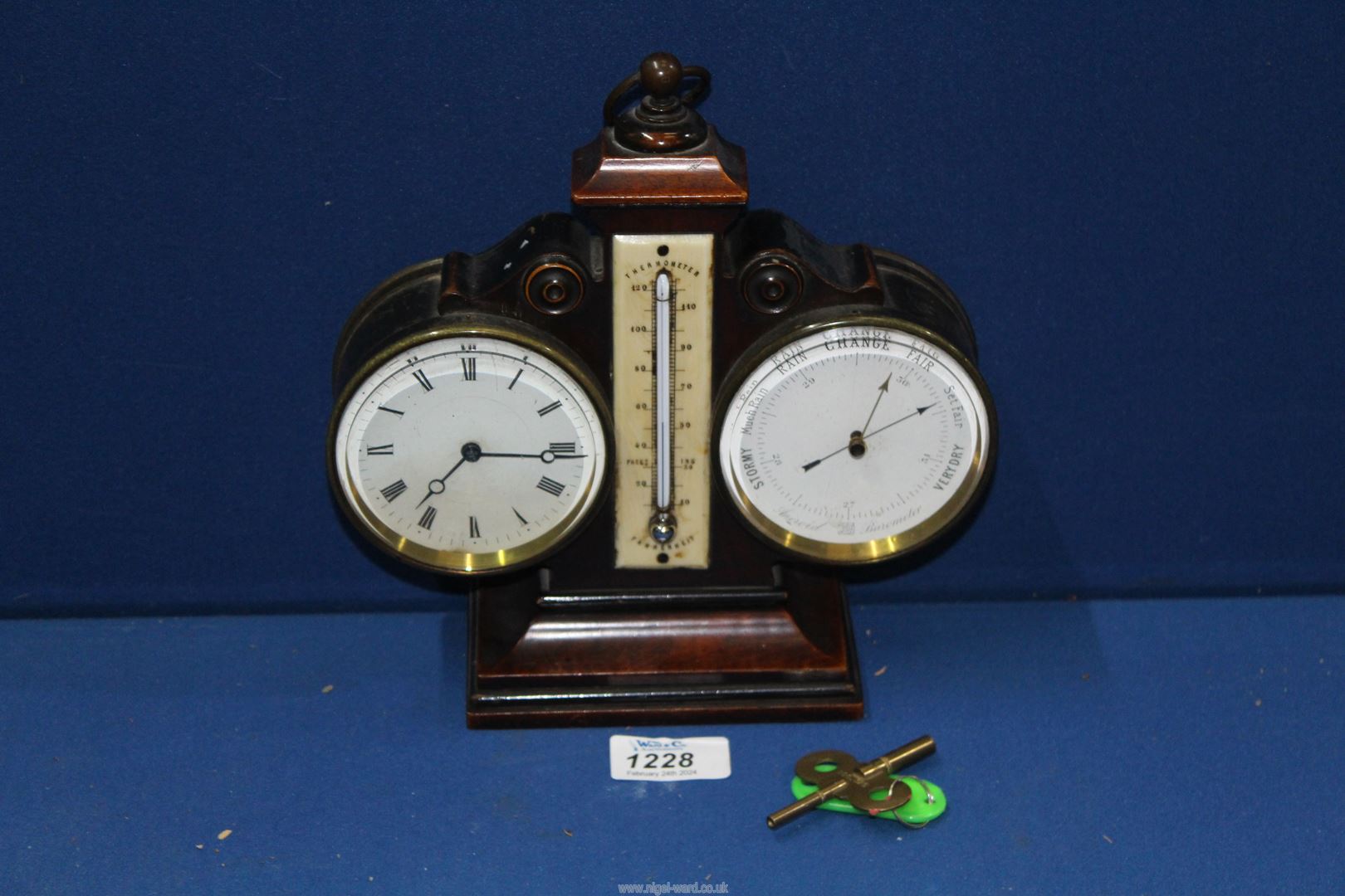 A combination barometer/ thermometer desk clock with key, 9" tall. - Image 2 of 2