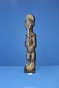 A Tribal Baule male figure (spirit-spouse) with elaborately braided carved beard,