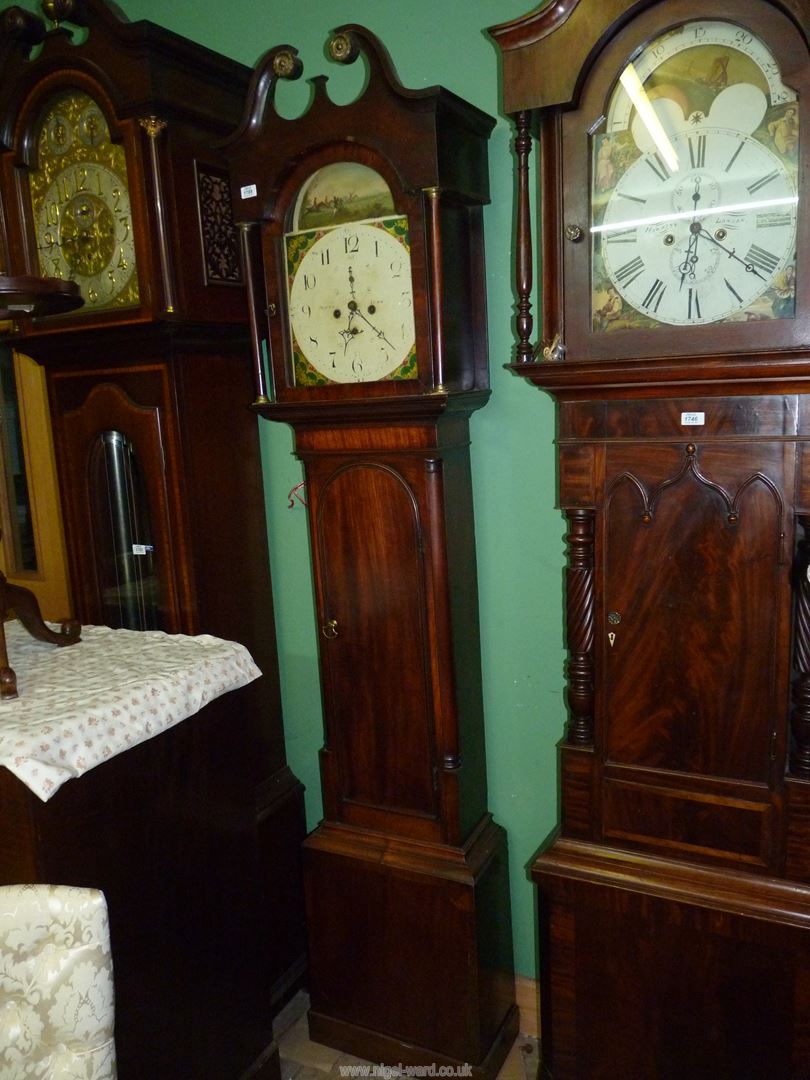 A Mahogany cased Longcase Clock having an arched door and mirrored swan-neck pediment,