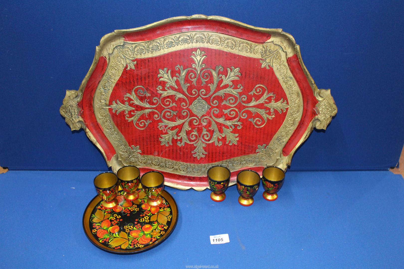 A colourful papier mache tray plus six matching egg cups and large ornate Italian tray in red and